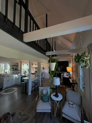 Interior living room with painted walls, ceiling, and trim in open-concept home with loft