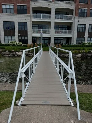 White painted railings and walkway with commercial building exterior featuring painted trim and window frames