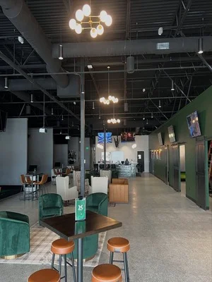 Commercial interior with sage green accent walls, white trim, and professional ceiling paint in open floor plan